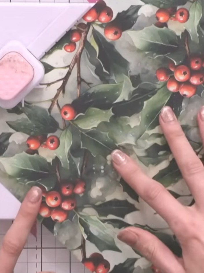 Step 3: Using the envelope maker tool set to XL, score across the holly and berry paper. Line up the XL marking again 