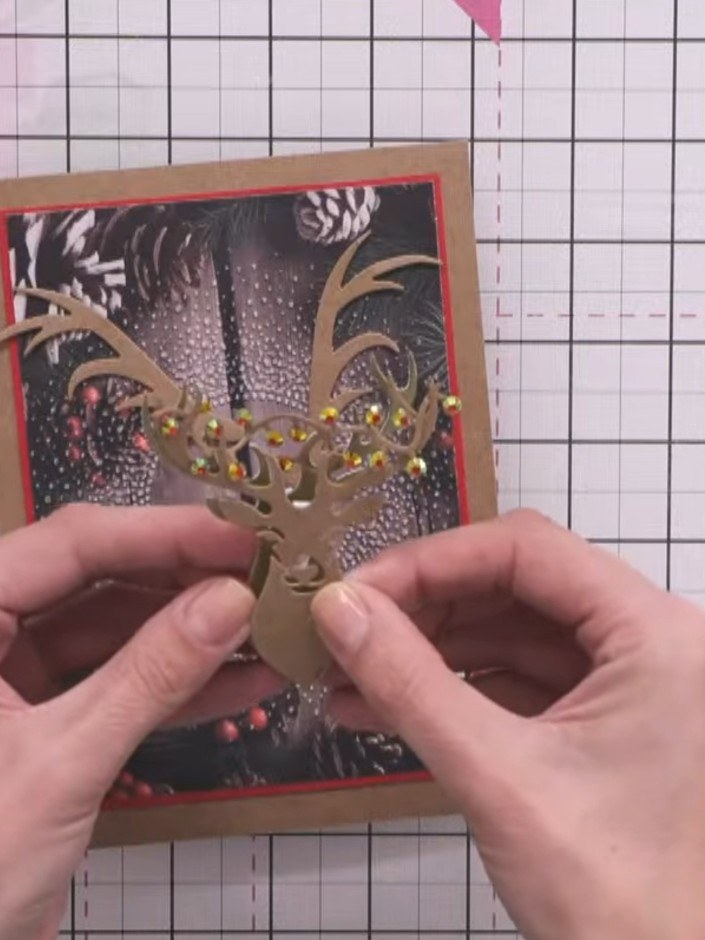 Step 4: Position the kraft stag piece with the embellished antlers slightly offset to the right and lower than the mai