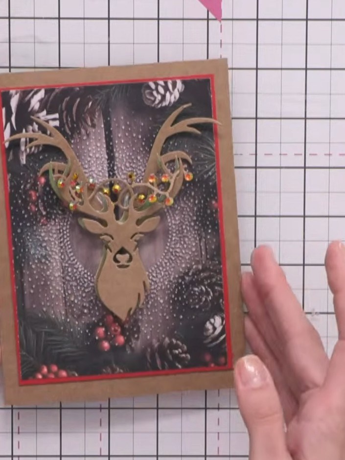 Step 8: Layer the larger antler die-cuts on top of the smaller ones using foam pads to add dimension. Position them ca