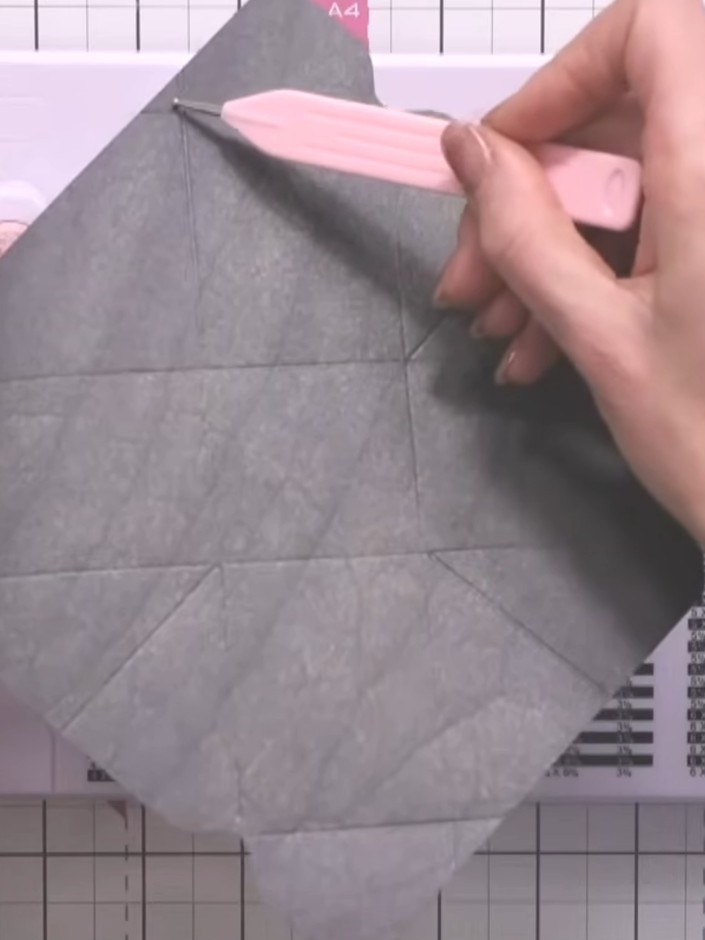 Step 6: Insert the pink liner into the grey envelope, creating a triangle shape at the top. The corners will form an e