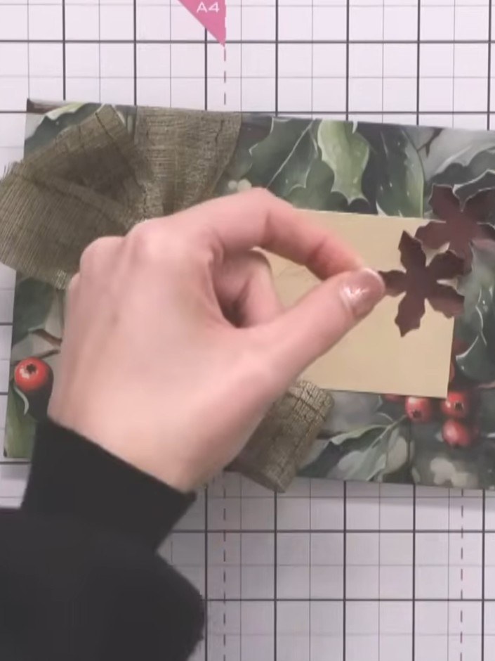 Step 6: Apply glue to the back of the decorated cream panel and attach it to the front of the envelope, positioning it