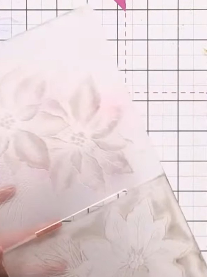 Step 5: Fill a spray bottle with water and lightly mist the inked embossing folder to activate the ink and create a wa
