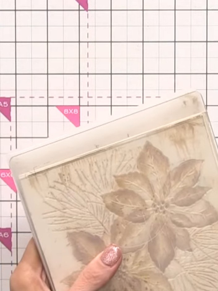 Step 8: Carefully open the embossing folder to reveal the embossed design on your cardstock, showing both the raised a