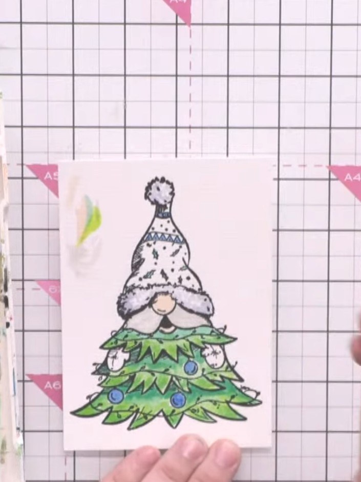 Step 3: Add red watercolour to the gnome's hat and white watercolour to the beard. Use a fine brush to apply the colou