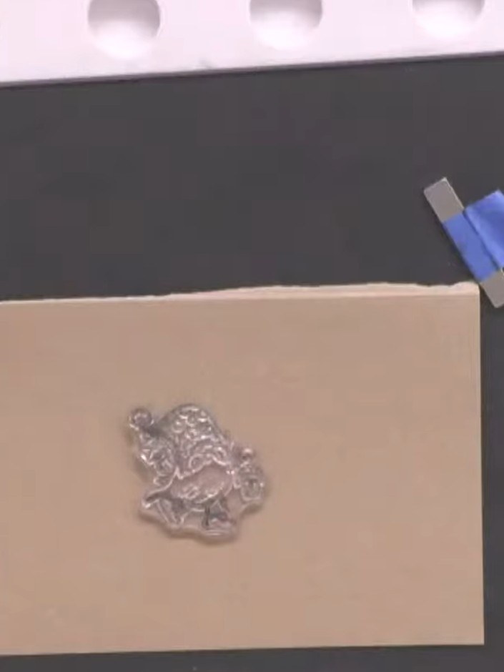 Step 1: Stamp the gnome character onto kraft card using black ink. Position the clear stamp on the card and press firm