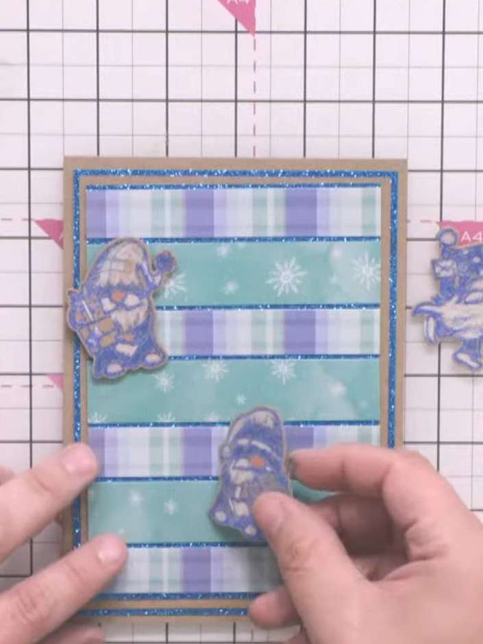Step 11: Add a sentiment stamp or die-cut element to complete your gnome character card. Position it appropriately on t