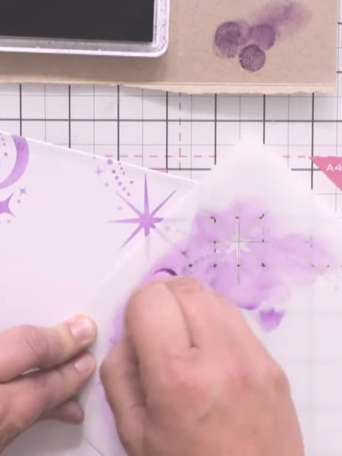 Step 5: Apply sparkly paste in purple through the stencil onto your card base, creating a festive stencilled backgroun