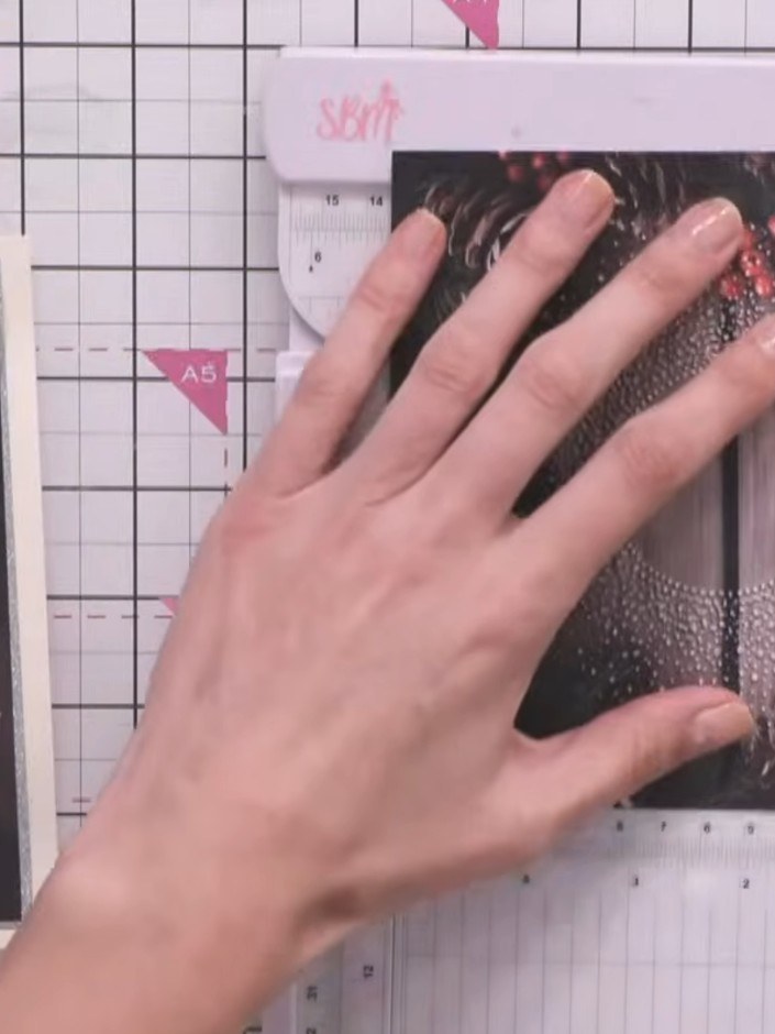 Step 2: Place the embossed piece onto a trimmer and cut away the ragged edges to create a neat rectangular card shape 