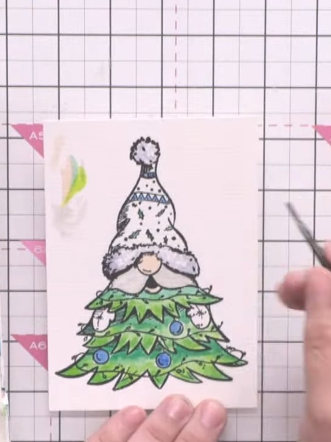 Step 3: Add white highlights to the gnome's beard and hat details using white watercolour or white crayon. Apply the w