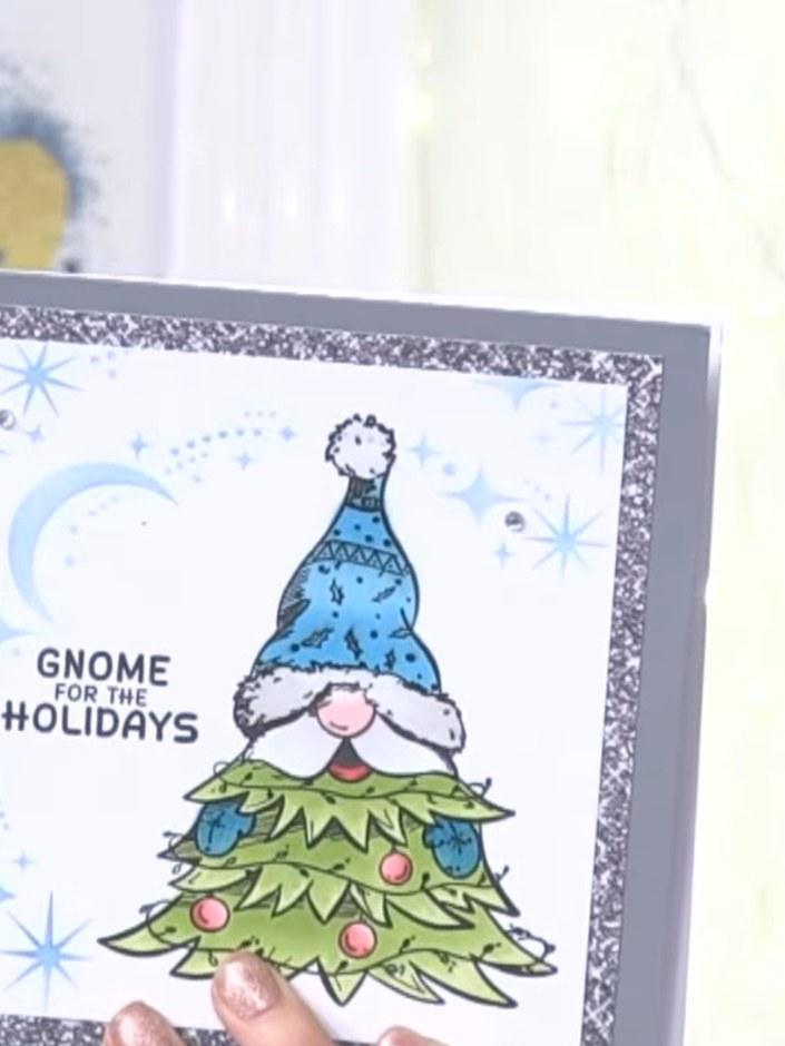 Step 2: Colour the stamped gnome image using blue ink for the hat, green for the Christmas tree body, and add pink and