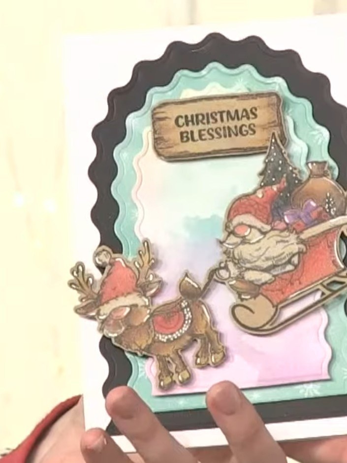 Step 6: Mount the finished topper onto your card base using adhesive. Position the layered gnome and sleigh scene cent