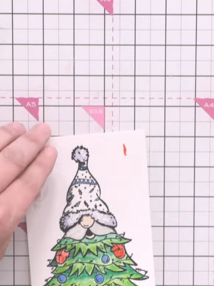 Step 5: Apply sparkly glitter powder (Wow Blue) to the embossed areas of the gnome character. Use a heat gun to set th
