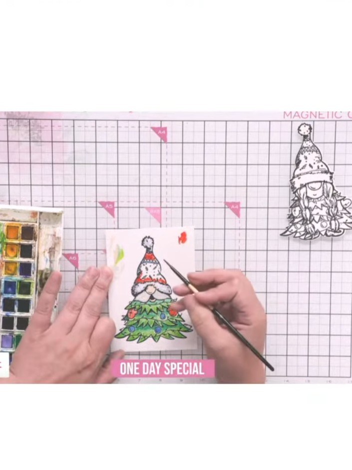 Step 7: Mount the coloured gnome die-cut onto your card base using 3D foam tape to add dimension. Position the gnome o