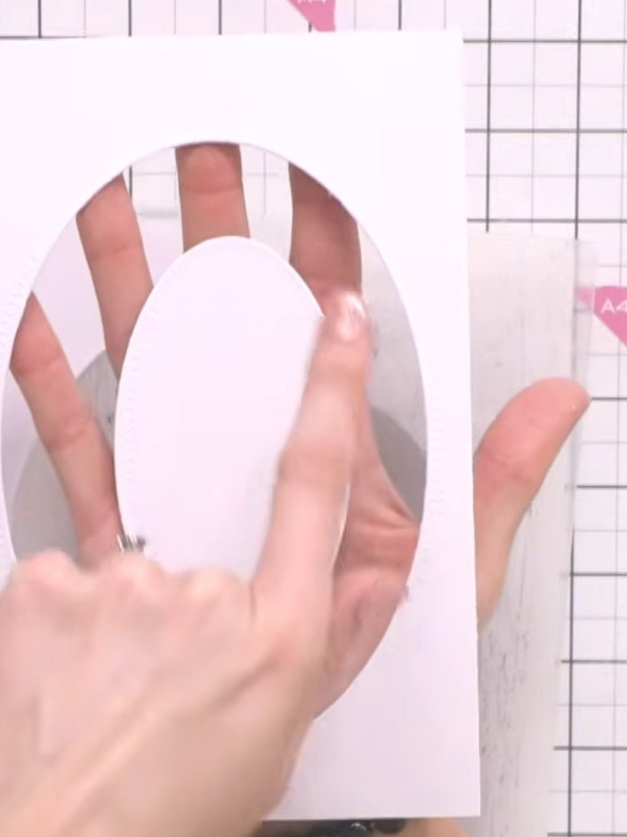 Step 4: Layer the acetate or vellum between the two cardstock ovals using adhesive foam pads. Position the acetate she