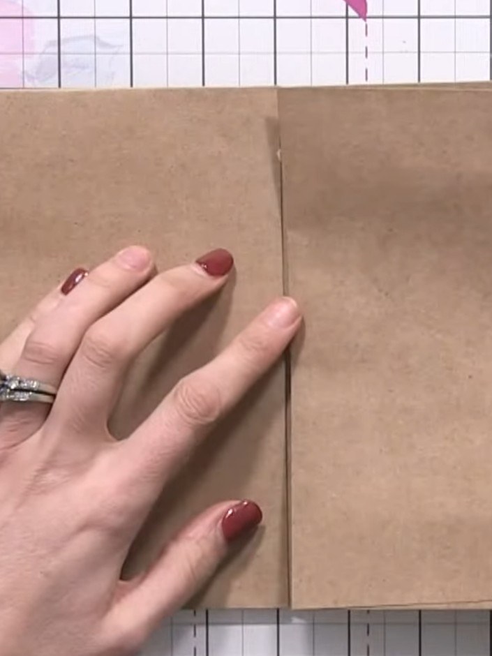 Step 4: Score one side of an envelope to create a hinge. Fold the scored envelope over and glue it inside a pocket to 