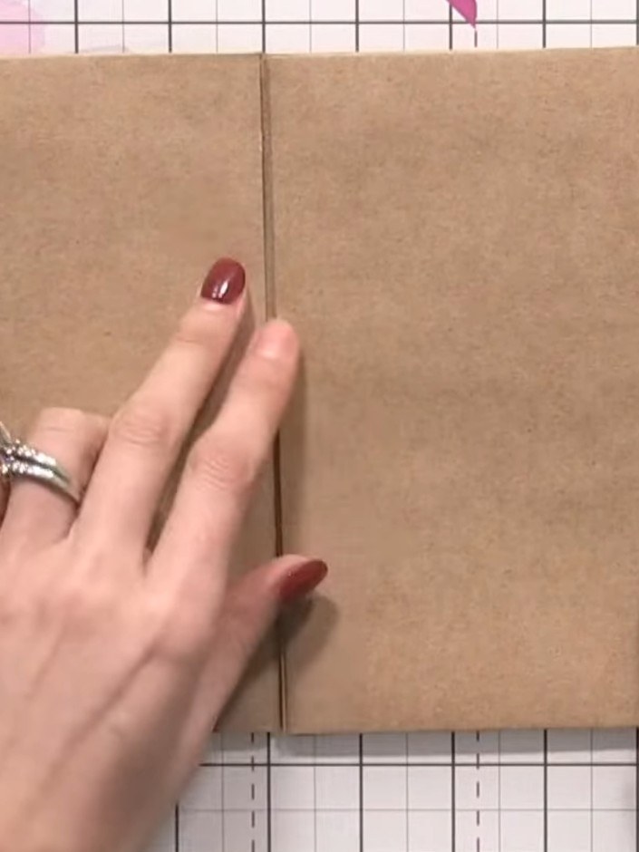Step 5: Apply glue to the front of your envelope and adhere your chosen Whispering Wings paper to create the album cov