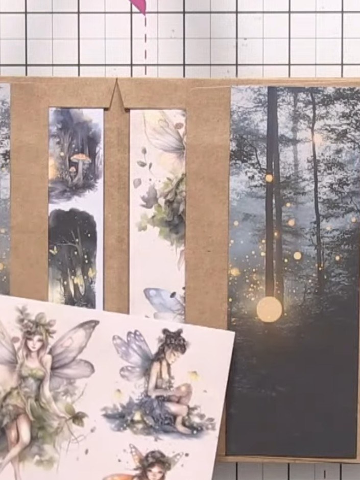 Step 8: Fussy cut fairy toppers and other embellishments from the Whispering Wings paper collection. Layer them over t