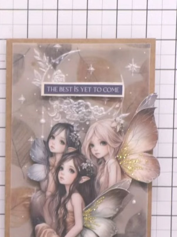 Step 12: Add small sparkle embellishments around the fairy image and along the embossed details using a pick-up tool. P