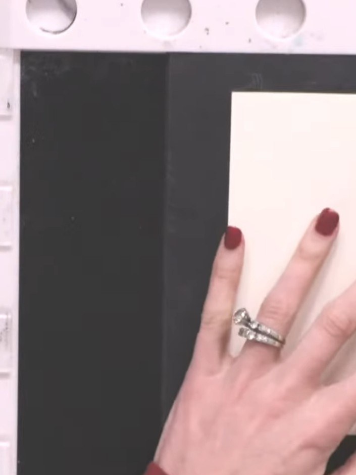 Step 2: Position your cream card stock on your craft mat and hold it in place. Using a sticky ink pad, randomly stamp 