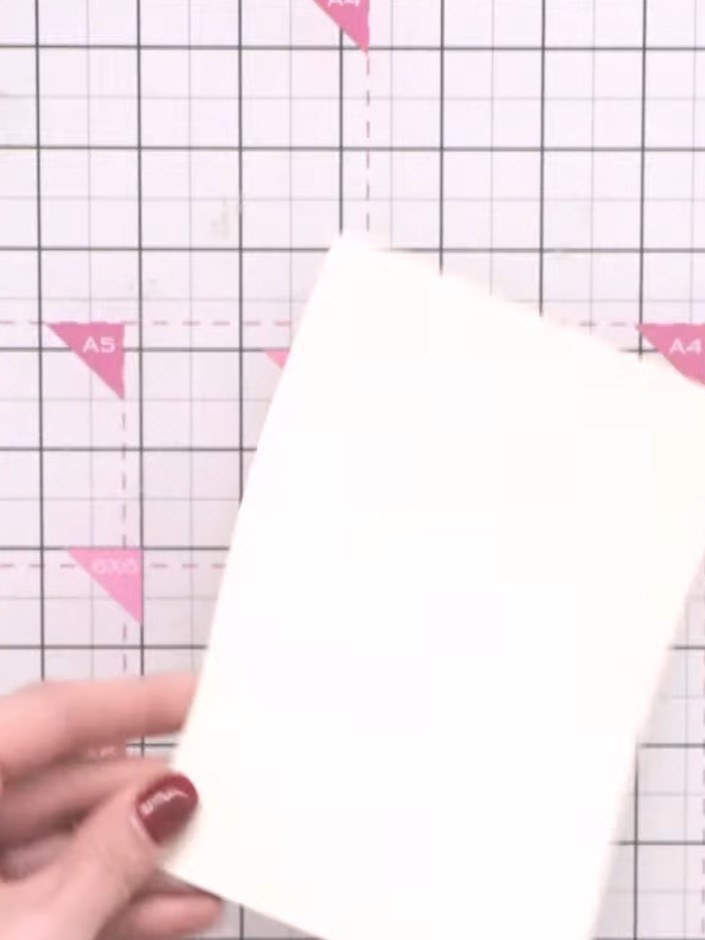 Step 5: Place brown ink on a craft mat and spray with water to create a puddle. Drop your stamped card stock into the 