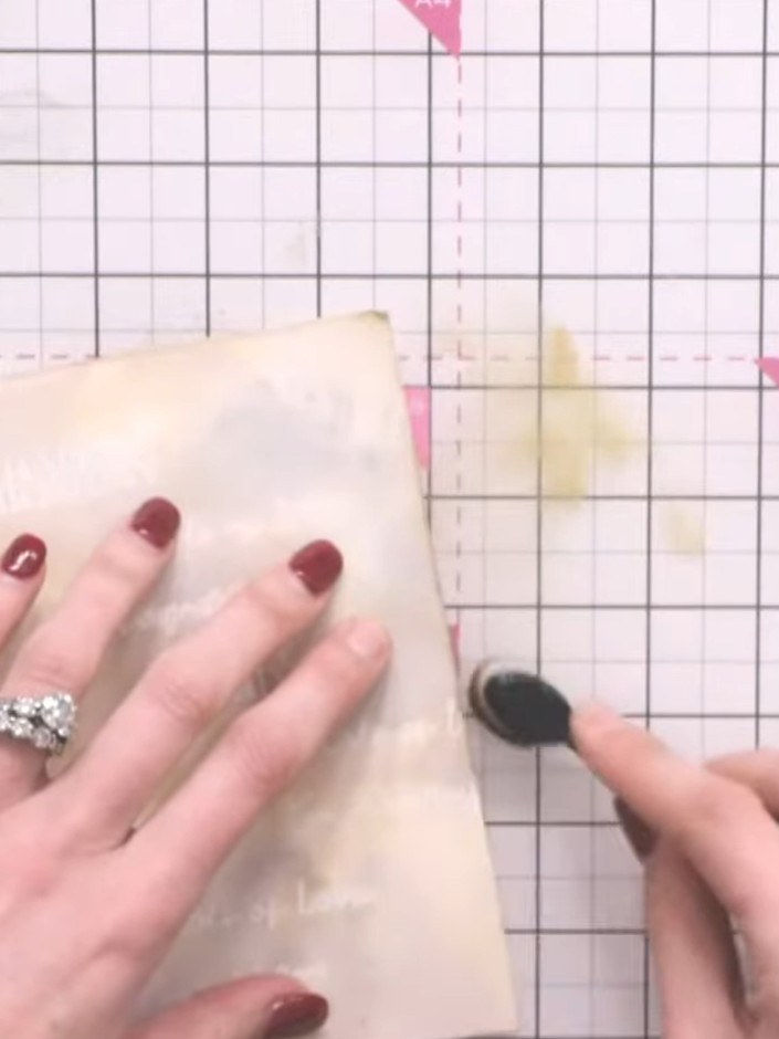 Step 8: Use a blending brush with brown Distress Oxide ink to add colour and texture around the edges of the cream car