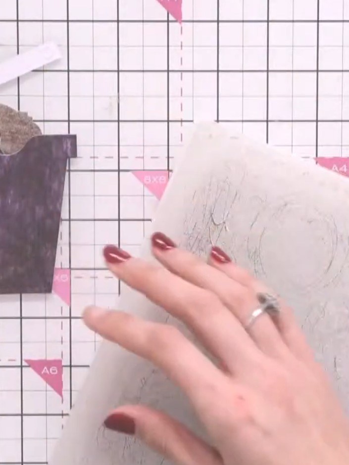 Step 8: Attach a decorative panel from your paper collection to the front cover, positioning it off to one side using 