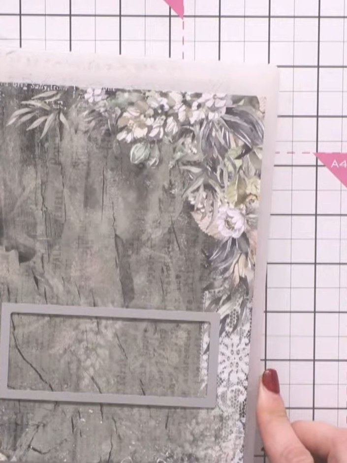 Step 3: Position the die-cut aperture frame on your decorative paper panel. This frame will create the window opening 