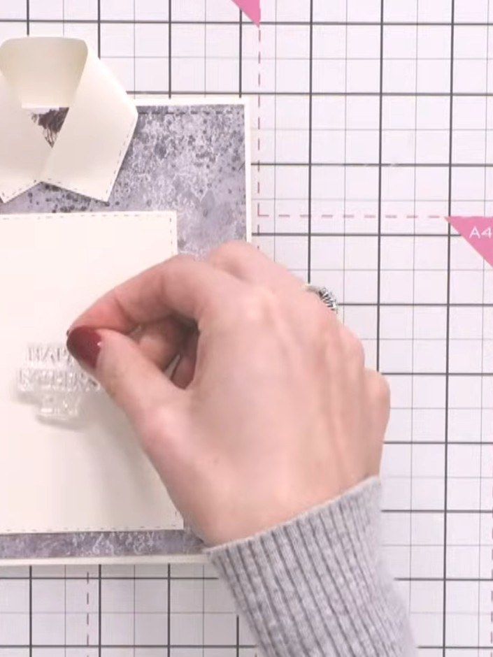 Step 11: Stamp a sentiment such as 'Happy Father's Day' onto the white pull-out insert using the Eureka 101 stamp plate