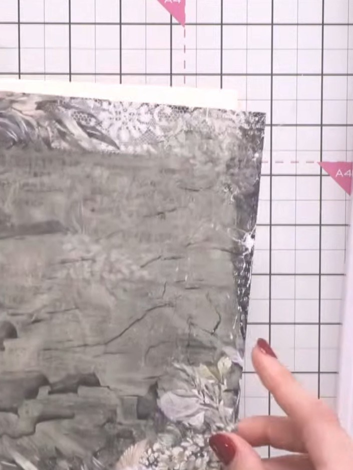 Step 3: Fold the scored edges of the 8x8 card inward to create a shirt-like shape. The folded sides should be visible,
