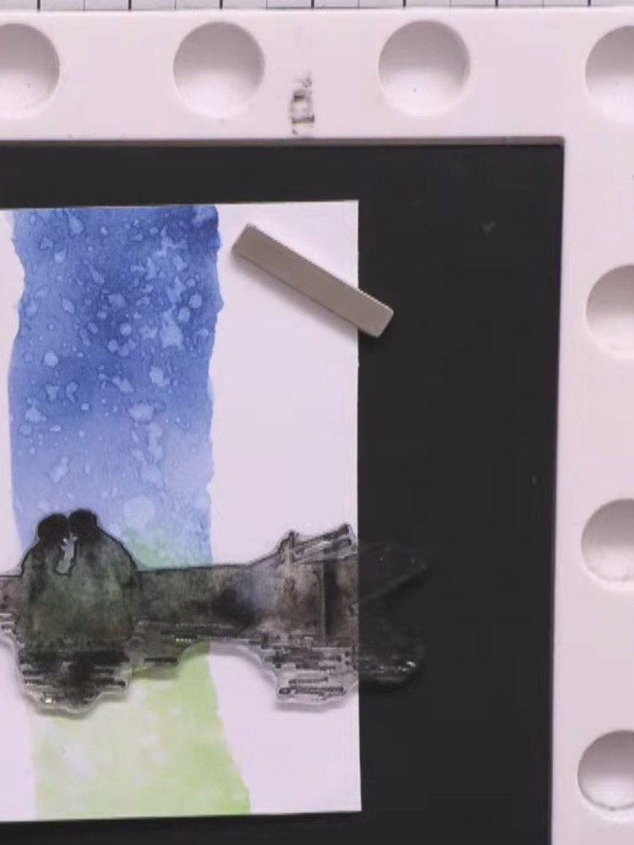 Step 10: Stamp the boat image from the Reflection Stamp set in black ink onto the lower portion of the panel, positioni