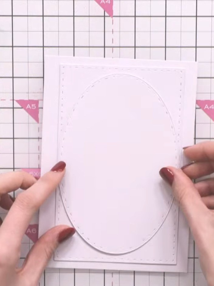 Step 4: Adhere each oval layer securely to the card base, ensuring they are centred and positioned as desired. Build u