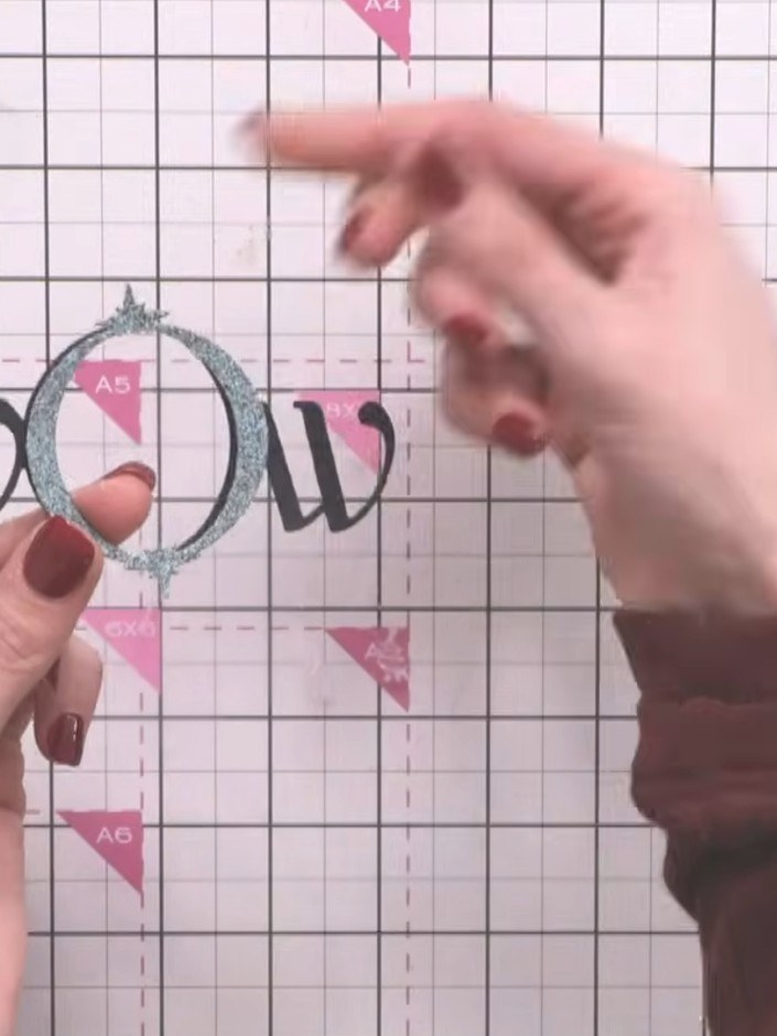 Step 2: Layer the die-cut rectangles on top of each other, starting with the largest glittery frame and working down t