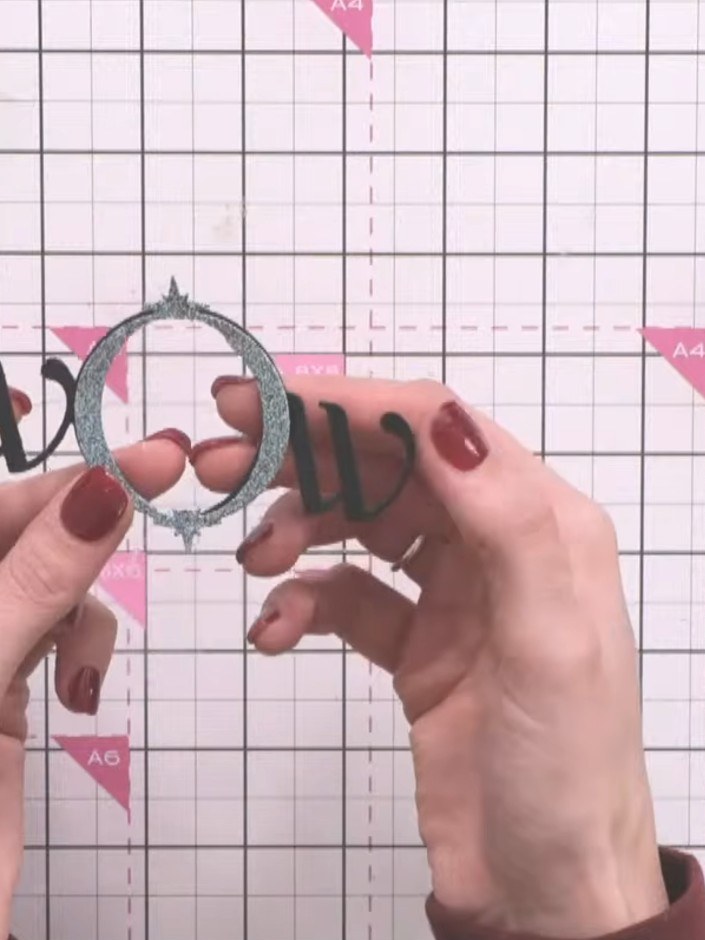 Step 4: Layer the die-cut frames together, adhering each piece securely to create the matted frame effect. Ensure the 