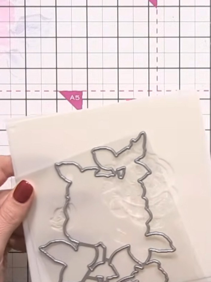 Step 1: Select the Classic Rose stencil and die set from your materials. Take a cream or white card blank as your base