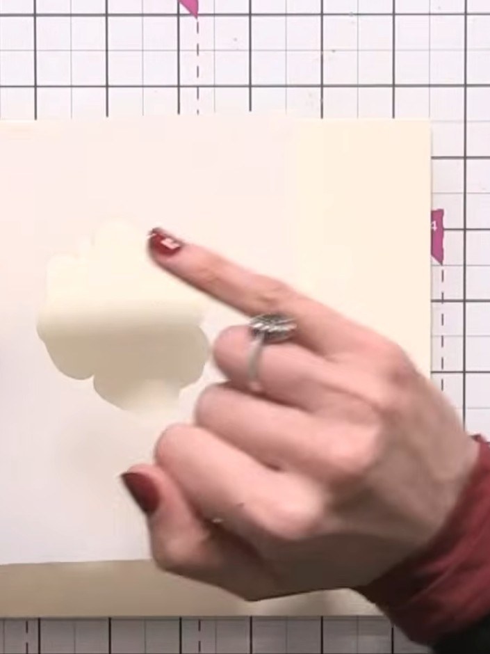 Step 4: Using a black ink pad, lightly tap ink through the first numbered stencil layer on the left side of the card t