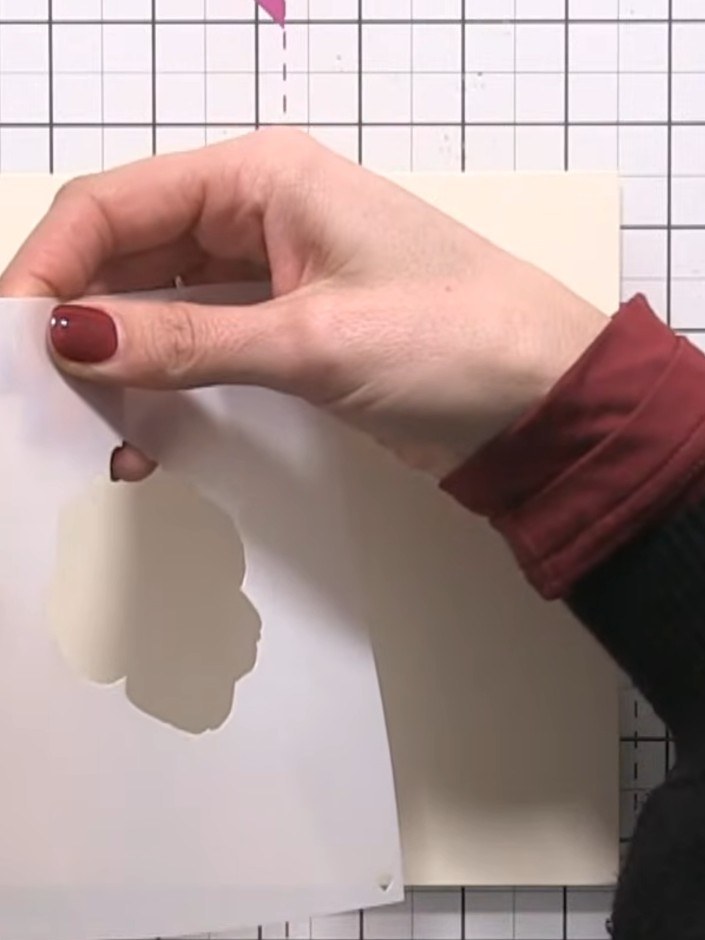 Step 5: Carefully remove the stencil from the card. Reposition the stencil over the card, covering the black and white