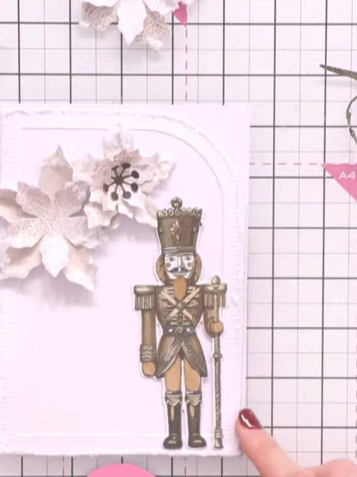 Step 6: Arrange the dried glittered poinsettia flowers in the lower right corner of your card, layering them to create