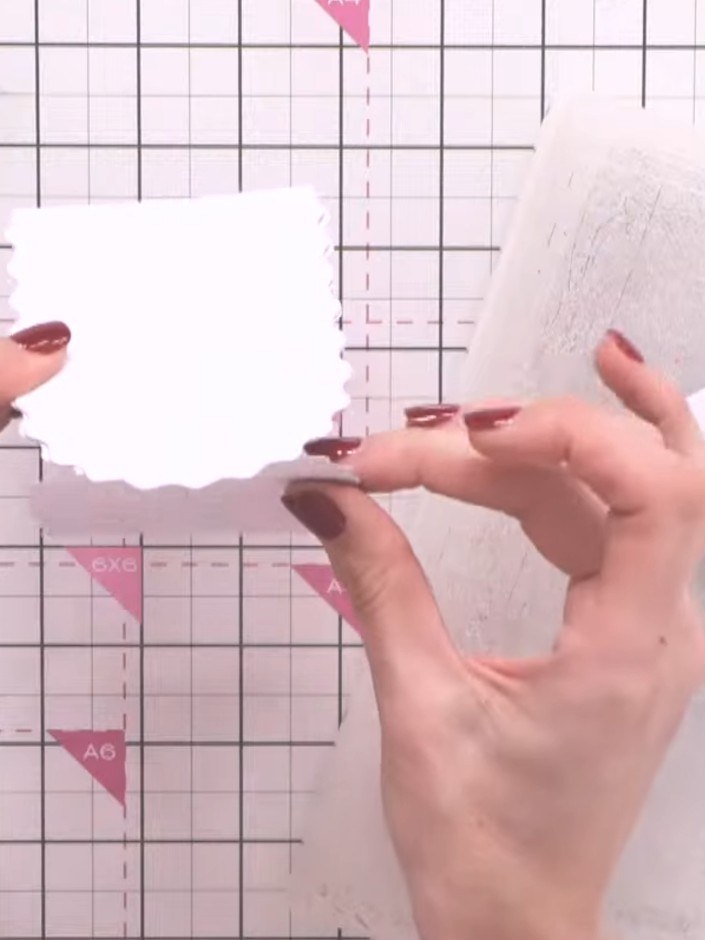 Step 6: Cut two wavy arch shapes from white cardstock. Score one piece down the centre vertically. Attach the scored p