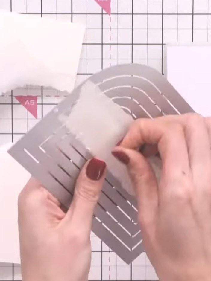 Step 3: Place your white card base with the nested dies positioned on top. Run the card and dies through your die cutt