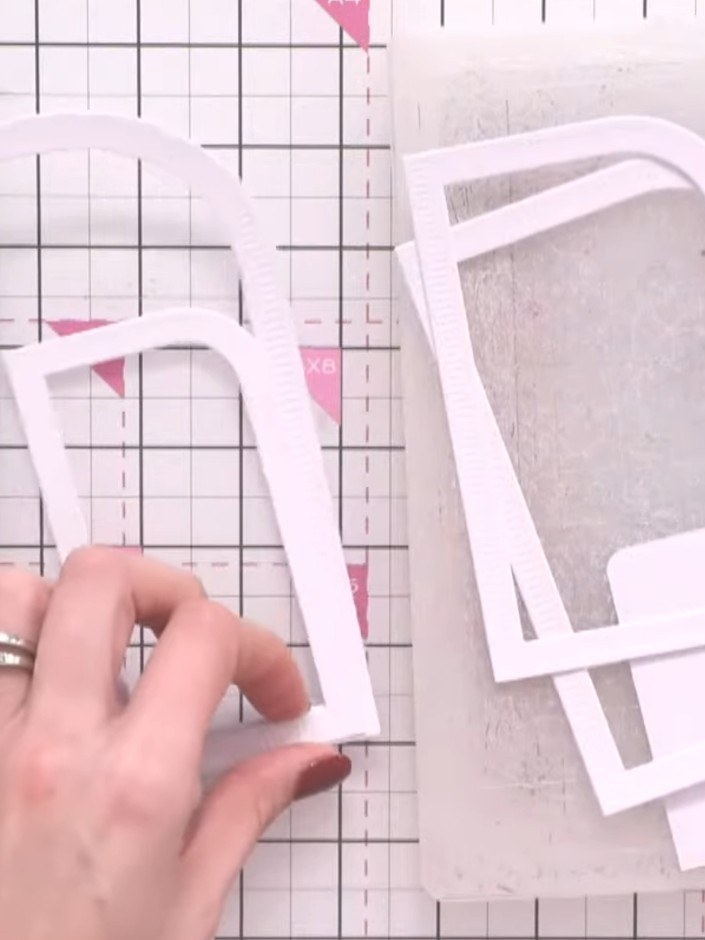 Step 6: Stack the white die-cut frames together to show how they nest inside one another and create a layered effect. 