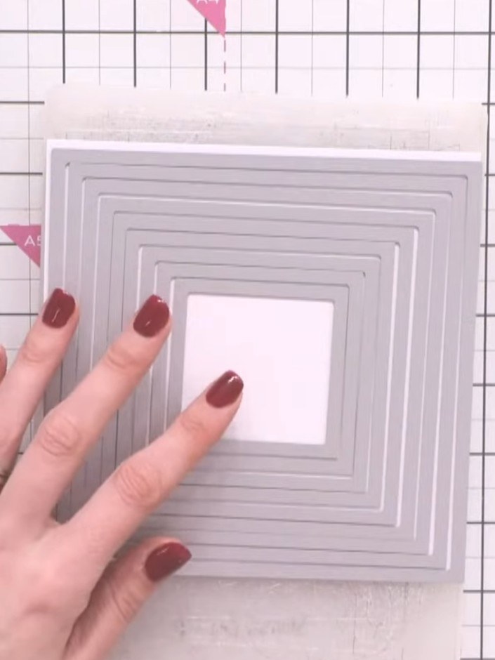 Step 5: Observe the dot-dash stitch detail embossed around each frame edge. The die creates multiple nested square fra