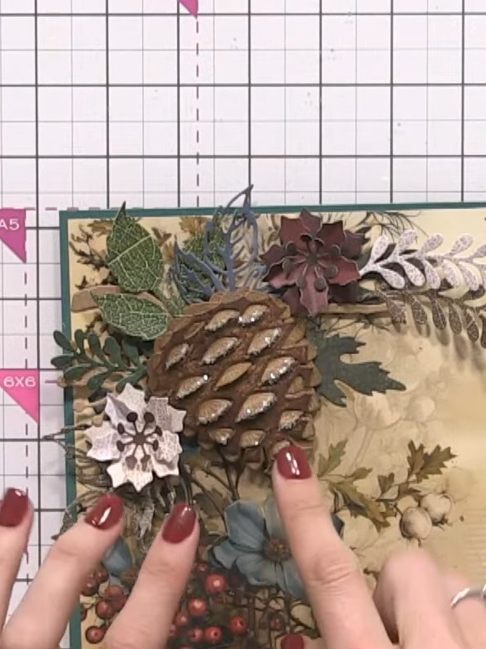 Step 11: Add gems or sparkle to the flower centres and raised details on the pine cone and other embellishments as desi
