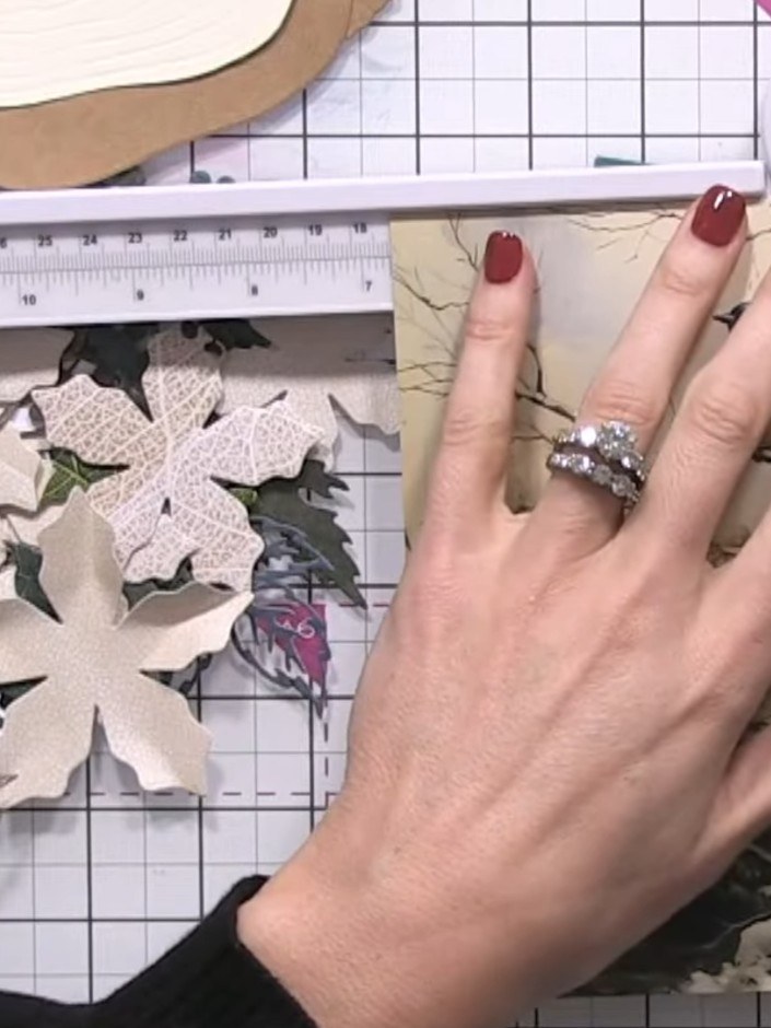Step 2: Die-cut multiple poinsettia petals from the Holly & Berry paper collection using the scoring board and die-cut