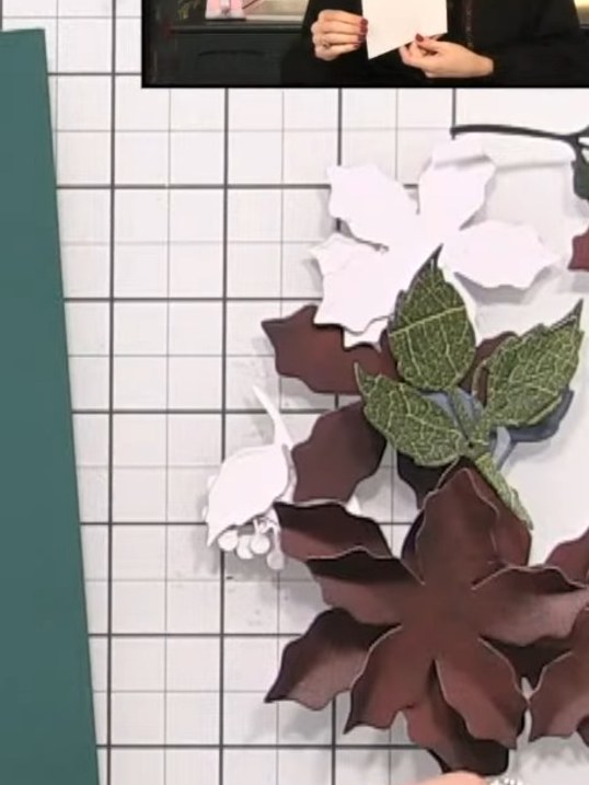 Step 3: Layer the poinsettia petals by stacking smaller petals inside larger ones. Pinch the petals together at the ba