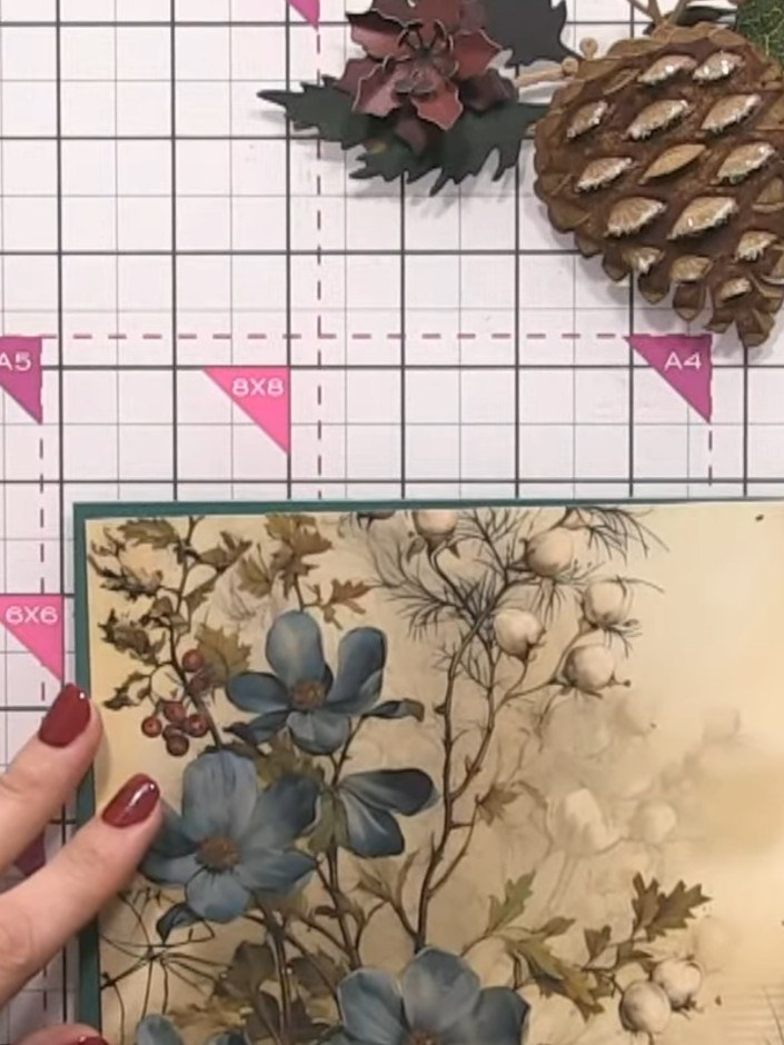 Step 8: Position the foliage pieces around the base of the pine cone, tucking the leaves under other elements to creat