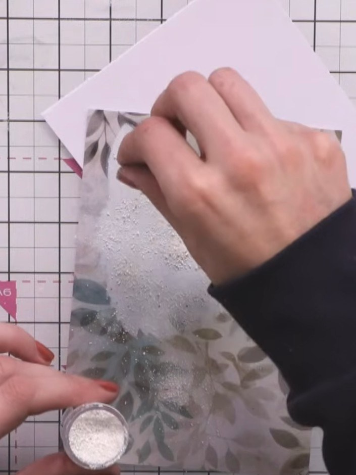 Step 6: Use a blending brush with black ink to create a subtle vignette around the edges of the white card, gently dar