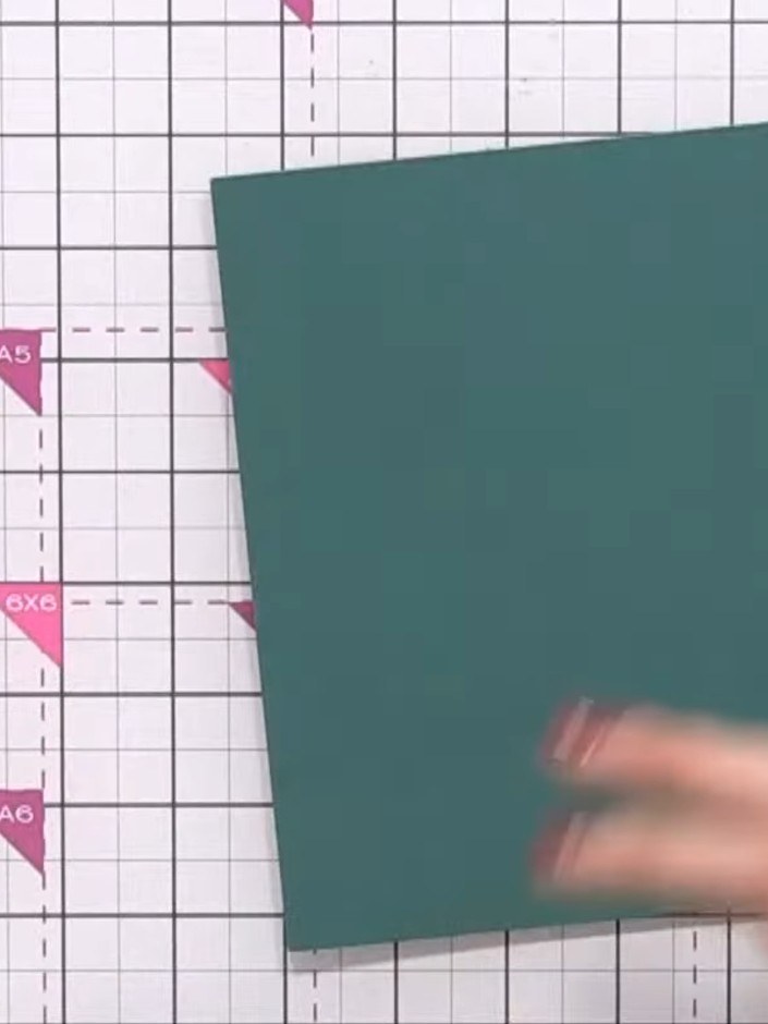 Step 5: Take a teal or dark green cardstock base and fold it in half to create your card blank. Score and fold to crea