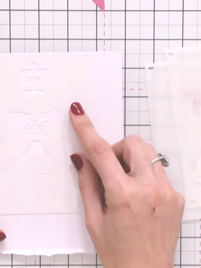 Step 1: Take a white card blank and position stencil number one at the edge of the card, lining it up carefully.