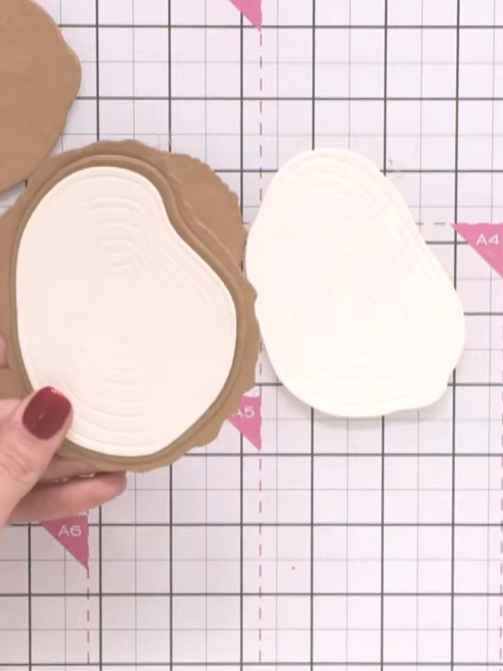 Step 3: Apply distress ink to the embossed white panel, working it into the grooves to create a realistic wood grain e