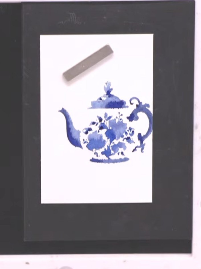Step 6: Align the detail stamp over the solid blue teapot image, using the packet as a guide to ensure proper placemen